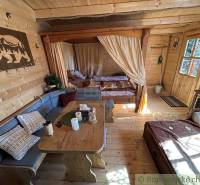 A family house with a wooden interior, comfortable seating, and a cozy atmosphere in a romantic cottage.