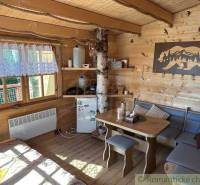 Interior of a wooden cabin, table next to the sofa, decorations in a rustic style, family home.