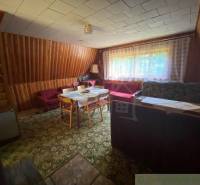 Living room in a wooden house, old furniture, carpets, and curtains. Family house.