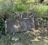 A stone cellar surrounded by dense vegetation offers rustic charm and natural harmony.