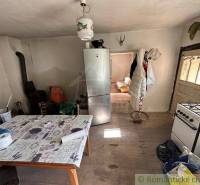 A kitchen with a wooden floor and furnishings, suitable for a family house.
