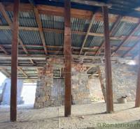 A building with wooden beams and concrete walls, in the roof construction of a family house.