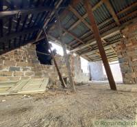 The attic in the old family house with unfinished brick walls and stored doors.