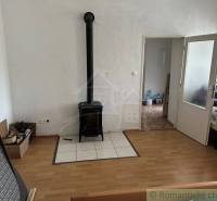 Living room with a tiled fireplace, doors, and boxes in the house.