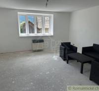 A room in a family house, black armchairs are seated, a large window with a view.