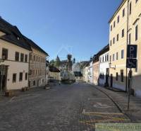 The historical center of Banská Štiavnica with a church, cobblestone streets, a family house in traditional style.