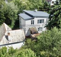 A family house in Nová Baňa surrounded by greenery and trees in a peaceful location.