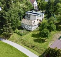 A family house in Nová Baňa surrounded by greenery and enclosed by a garden.