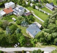 Aerial view of a family house in Nová Baňa, surrounded by greenery and neighboring houses.