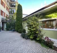 Building with greenery on Nitrianska Street, outdoor offices and garden furniture.