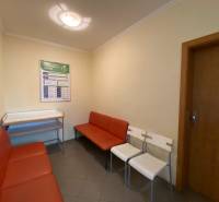 Waiting room in front of the office on Nitrianska Street with seating and an information board.