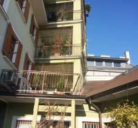 A building with greenery on balconies, Nitrianska street, office spaces under the blue sky.