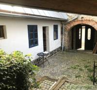 Stone courtyard with an arch, named **Roman** and Unique properties in a romantic style.