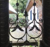 Stone courtyard with a brick wall, decorative grilles, unique properties, romantic cottages.