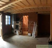 Rustic interior of the house with entrance doors and a sturdy wood stove. Unique property.