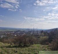 A view of a picturesque town in the valley, surrounded by nature and meadows. Family house.