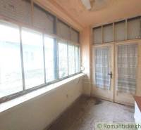Orange enclosed space, windows, doors, simplicity, cottage, well-preserved condition, rustic appearance.