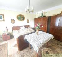 A room with a bed and wardrobes. A cottage with decorations creates a cozy atmospheric space.