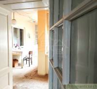 Interior with wooden doors, a flower table, and yellow walls at the cottage.