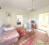 The room in the picture shows a cozy cabin with a sofa, a rug, and a television.