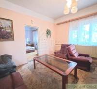 Living room of a family house with a painting and comfortable armchairs, connected to the bedroom.