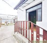 Entrance to a family house with the possibility of renovated spaces and surrounding garden.