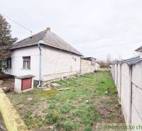 Family house with a garden, fence, tree, and grassy plot in a quiet location.