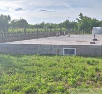 A building on a plain surrounded by vineyards and gardens, ready for the next project.