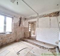 An unfinished renovation of a cottage with exposed walls and an old design ready for renewal.