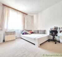 Bedroom in a family house with a bed, a desk, and Scandinavian decor.
