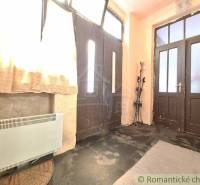 Entrance hall with large doors, curtains, and skis, located in a family house.