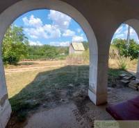 The arched veranda offers a view of the landscape and unique properties in the area.