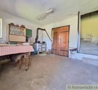 A rustic interior with an old stove and wooden furniture is offered by Unique Properties.