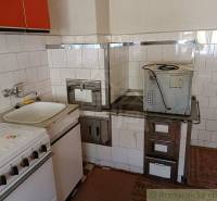 A vintage kitchen with a traditional stove and sink; an ideal place in a cottage.