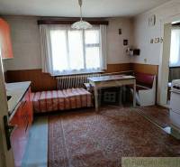 Kitchen and cottage: rustic interior with a couch, wooden furniture, carpet, and window.
