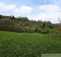 Green meadows and hills provide a peaceful setting for a family home in nature.