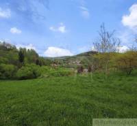 Landscape panorama with a village in the valley, greenery, and blue sky, Family house.