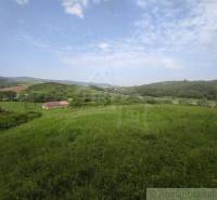 Hills and meadows, a family house, beautiful countryside with a blue sky.