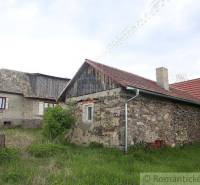 An old family house and a stone cottage in the countryside surrounded by greenery and nature.