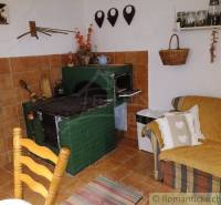 Rustic kitchen with a traditional tiled stove, family house, and cozy furniture.