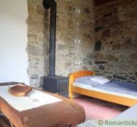 Stone wall with a stove in a cozy cabin-style room.