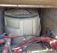 A plastic tank with pipes in the basement, the foundation of a family house.