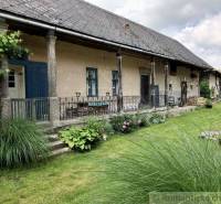 The picture shows a cozy country family house with a spacious garden.