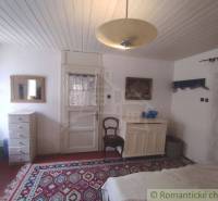 A room with a wooden ceiling, carpet, and furniture in a family house characterizes coziness.