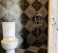 Bathroom and family house: shower corner with geometric tiles in black and white.