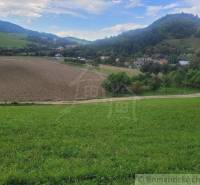 Grassy hills surround fertile fields in a peaceful rural setting near gardens.