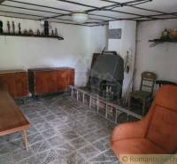 A room in a family house with antique furniture and decorations on the shelves.