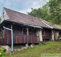 Old wooden cottage, suitable as a family house, surrounded by trees with a garden.