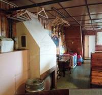 The interior of a wooden cabin with seating, coat hooks, and decorations creates a pleasant atmosphere.