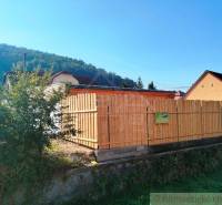 Family house with a garden, wooden fence, nature, forest, hills, property for sale.